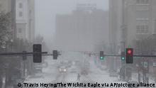 Traffic moves during an emergency snow squall issued by the National Weather Service in Wichita, Kansas, on Thursday, Dec. 22, 2022 as snow, plunging temperatures and high winds made their way through the area. Temperatures plunged far and fast Thursday as a winter storm formed ahead of Christmas weekend, promising heavy snow, ice, flooding and powerful winds across a broad swath of the country and complicating holiday travel.(Travis Heying /The Wichita Eagle via AP)