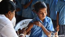2018***
An India health worker injects a measles and rubella (MR) vaccine to a student at a government school at Hatibhangi village in Morigoan in Assam state on September 4, 2018. (Photo by Biju BORO / AFP)