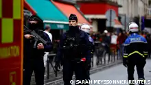 French police and firefighters secure a street after gunshots were fired killing two people and injuring several in a central district of Paris, France, December 23, 2022. REUTERS/Sarah Meyssonnier 