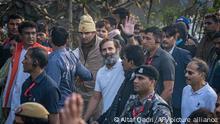 Rahul Gandhi, leader of India's opposition Congress party, centre in white T-shirt, waves to his supporters during a march, in New Delhi, India, Saturday, Dec. 24, 2022. Rahul Gandhi, leader of India's beleaguered opposition Congress party, on Saturday marched in New Delhi along with his supporters, part of his five-month-long 3,570km (2,218-mile) countrywide trek through 12 states that began 105 days ago.(AP Photo/Altaf Qadri)