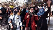 Afghan women chant slogans to protest against the ban on university education for women, in Kabul on December 22, 2022. - A small group of Afghan women staged a defiant protest in Kabul on December 22 against a Taliban order banning them from universities, an activist said, adding that some were arrested. (Photo by AFP)