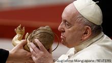 Pope Francis holds and kisses a statue of Baby Jesus during the Christmas Eve mass in St. Peter's Basilica at the Vatican, December 24, 2022. REUTERS/Guglielmo Mangiapane TPX IMAGES OF THE DAY 