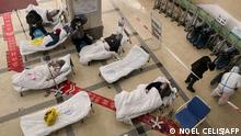 Covid-19 coronavirus patients lie on hospital beds in the lobby of the Chongqing No. 5 People's Hospital in China's southwestern city of Chongqing on December 23, 2022. (Photo by Noel CELIS / AFP)