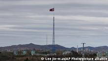 FILE - A North Korean flag flutters in the wind atop a 160-meter tower in North Korea's village Gijungdongseen, as seen from the Taesungdong freedom village inside the demilitarized zone in Paju, South Korea, on April 27, 2018. South Korea said Monday, Dec. 26, 2022, it fired warning shots after North Korean drones violated the Southâ€™s airspace. (AP Photo/Lee Jin-man, File)