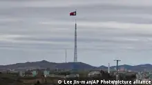 FILE - A North Korean flag flutters in the wind atop a 160-meter tower in North Korea's village Gijungdongseen, as seen from the Taesungdong freedom village inside the demilitarized zone in Paju, South Korea, on April 27, 2018. South Korea said Monday, Dec. 26, 2022, it fired warning shots after North Korean drones violated the Southâ€™s airspace. (AP Photo/Lee Jin-man, File)
