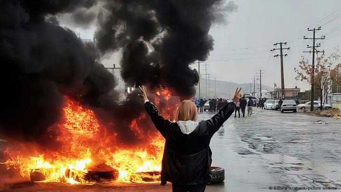 Iranian woman without the headscarf mandatory for women clash with security forces.