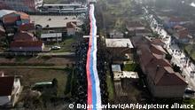 Kosovo-Serben tragen eine riesige serbische Flagge während eines Protests in der Nähe des Dorfes Rudare, nördlich des serbisch dominierten Teils der ethnisch geteilten Stadt Mitrovica. Das serbische Militär hat bei der Nato-geführten Friedenstruppe KFOR die Erlaubnis beantragt, mit 1000 Mann ins Kosovo einrücken zu können. +++ dpa-Bildfunk +++