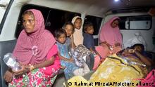 Ethnic Rohingya women and children sit inside an ambulance upon arrival at a temporary shelter after their boat landed in Pidie, Aceh province, Indonesia, Monday, Dec. 26, 2022. A second group in two days of weak and exhausted Rohingya Muslims landed on a beach in Indonesia's northernmost province of Aceh on Monday after weeks at sea, officials said. (AP Photo/Rahmat Mirza)