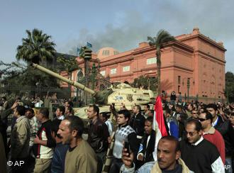 Manifestantes marchan frente a un tanque del Ejército en El Cairo.