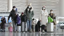 27.12.2022+++ Passengers wearing face masks pull baggage at a departure lobby in Beijing Capital International Airport on Dec. 27, 2022, after the central government recently dropped its zero-COVID policy. (Kyodo)