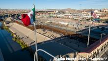 EL PASO, TEXAS - DECEMBER 22: An aerial view of the Mexican and American flags fly over an international bridge as immigrants line up next to the U.S.-Mexico border fence to seek asylum on December 22, 2022 in El Paso, Texas. A spike in the number of migrants seeking asylum in the United States has challenged local, state and federal authorities. The numbers are expected to increase as the fate of the Title 42 authority to expel migrants remains in limbo pending a Supreme Court decision expected after Christmas. John Moore/Getty Images/AFP (Photo by JOHN MOORE / GETTY IMAGES NORTH AMERICA / Getty Images via AFP)