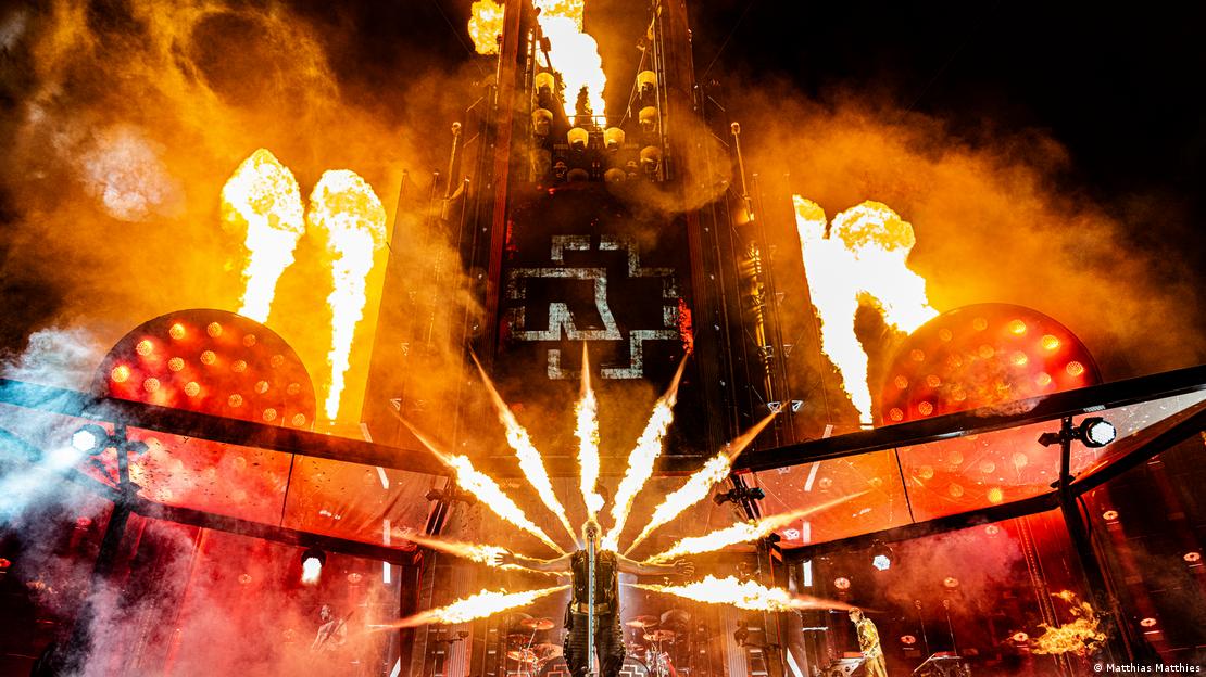  Rammstein Singer Till Lindemann in Prague with flames appearing to shoot out of his back.