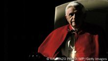 TOPSHOT - The cross of Pope Benedict XVI reflects the sun as he attends his traditional weekly general audience in St Peter's square 07 December 2005 at Vatican. The pontiff will celebrate a mass on 08 December 2005 for the fortieth anniversary of the closing of the second Vatican Ecumenical Council, a revolutionary event in the Catholic Church that many think failed to live up to its promise. (Photo by Vincenzo PINTO / AFP) (Photo by VINCENZO PINTO/AFP via Getty Images)