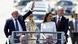 Brazil's new president Lula da Silva waves to his supporters from a vehicle in Brasilia