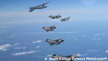 This handout photo taken on December 20, 2022 and provided by South Korean Defence Ministry in Seoul shows a US Air Force B-52H strategic bomber (top), a US Air Force C-17 cargo aircraft (top R) and four South Korean Air Force F-35A fighter jets flying over South Korea during a joint air drill after North Korea claimed it held a successful test launch of a spy satellite. (Photo by Handout / South Korean Defence Ministry / AFP) / RESTRICTED TO EDITORIAL USE - MANDATORY CREDIT AFP PHOTO / South Korean Defence Ministry - NO MARKETING NO ADVERTISING CAMPAIGNS - DISTRIBUTED AS A SERVICE TO CLIENTS