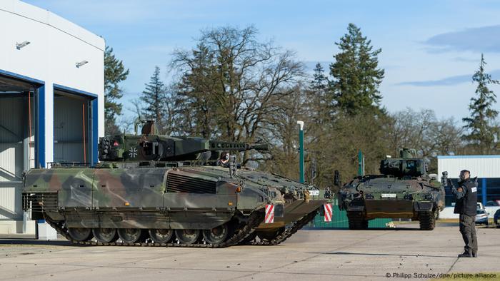 Ein Schützenpanzer der Bundeswehr vom Typ Puma wird auf einem Kasernengelände aus einer Halle gefahren.