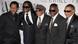 Fred White (far left) with his brother Verdine White, Al McKay, Philip Bailey and Ralph Johnson. All five men are wearing black suits. Fred White (far left) with his brother Verdine White, Al McKay, Philip Bailey and Ralph Johnson. All five men are wearing black suits.