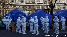 Pandemic prevention workers gather before their shift to look after buildings where residents do home quarantine, as coronavirus disease (COVID-19) outbreaks continue in Beijing, December 8, 2022. REUTERS/Thomas Peter TPX IMAGES OF THE DAY 