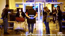 A chinese traveller leaves the arrival hall of RomeFiumicino International Airport, near Rome, on December 29, 2022 after being tested for the Covid-19 coronavirus. (Photo by Filippo MONTEFORTE / AFP) (Photo by FILIPPO MONTEFORTE/AFP via Getty Images)
