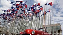 FILE - A classic American convertible car passes beside the United States embassy as Cuban flags fly at the Anti-Imperialist Tribune, a massive stage on the Malecon seaside promenade in Havana, Cuba, July 26, 2015. The United States Embassy in Cuba is opening visa and consular services on Wednesday, Jan 4, 2023. It was the first time since a spate of unexplained health incidents among diplomatic staff in 2017 slashed American presence in Havana(AP Photo/Desmond Boylan, File)