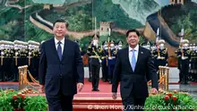 In this photo released by Xinhua News Agency, Visiting Philippine President Ferdinand Marcos Jr., right, walks with Chinese President Xi Jinping after reviewing an honor guard during a welcome ceremony at the Great Hall of the People in Beijing, Wednesday, Jan. 4, 2023. Philippine President Ferdinand Marcos Jr. is pushing for closer economic ties on a visit to China that seeks to sidestep territorial disputes in the South China Sea. (Shen Hong/Xinhua via AP)