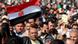 A protestor waves the Egyptian national flag during a protest in Tahrir Square