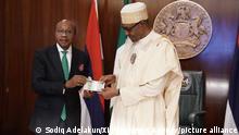(221124) -- ABUJA, Nov. 24, 2022 (Xinhua) -- Nigerian President Muhammadu Buhari(R) and Godwin Emefiele, the Governor of the Central Bank of Nigeria, present the re-designed banknotes of Nigerian naira in Abuja, Nigeria, on Nov. 23, 2022. Nigerian President Muhammadu Buhari on Wednesday launched the re-designed local banknotes to control the supply of the Nigerian naira, the local currency of the most populous African country. (Photo by Sodiq/Xinhua)