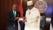 Nigerian President Muhammadu Buhari and Godwin Emefiele, the governor of the Central Bank of Nigeria, present the redesigned banknotes of Nigerian naira