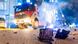 A smoldering firework on the street, a fire truck and police car in the background A smoldering firework on the street, a fire truck and police car in the background