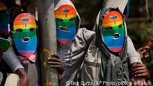 FIle - Kenyan members and supporters of the LGTB community wear masks to preserve their anonymity as they stage a protest in Nairobi, Kenya, Monday, Feb. 10, 2014. Police in Kenya are investigating the death of LGBT activist Edwin Chiloba, whose body was found on Wednesday, Jan. 4, 2023, stuffed in a metal box on a road in Uasin Gishu County, in the west of the country. (AP Photo/Ben Curtis, File)