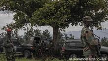 M23 rebels guard the area during the meeting between the East African Regional Force (EACRF) officials and M23 rebels during the handover ceremony at Rumangabo camp in eastern Democratic Republic of Congo on January 6, 2023. (Photo by Guerchom Ndebo / AFP)