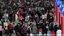 In this photo released by Xinhua News Agency, People wearing face masks with their luggage prepare to catch their trains at the North Railway Station in Shenzhen in south China's Guangdong province, Saturday, Jan. 7, 2023. China is now facing a surge in COVID-19 outbreak cases and hospitalizations in major cities and is bracing for a further spread into less developed areas with the start of the Lunar New Year travel rush, set to get underway in coming days. (Liang Xu/Xinhua via AP)