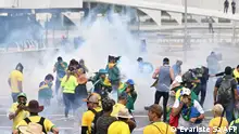 Supporters of Brazilian former President Jair Bolsonaro clash with the police during a demonstration outside the Planalto Palace in Brasilia on January 8, 2023. (Photo by EVARISTO SA / AFP)