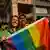 Two people hold up a rainbow flag during Delhi's Pride march in 2023