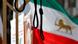 A gallows made of wood with an Iran flag seen in the background A gallows made of wood with an Iran flag seen in the background