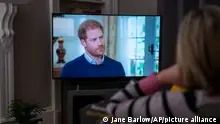 A person at home in Edinburgh watches Prince Harry, the Duke of Sussex, being interviewed by ITV's Tom Bradby during Harry: The Interview, two days before his controversial autobiography Spare is published, Sunday, Jan. 8, 2023. (Jane Barlow/PA via AP)