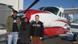 Left: John Leenus, Middle: Anju Varghese, Right: Axel Beimdiek standing in front a a Chessna plane Left: John Leenus, Middle: Anju Varghese, Right: Axel Beimdiek standing in front a a Chessna plane