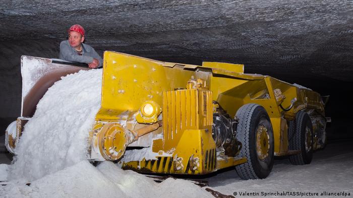 Ein Arbeiter entlädt die Salzfracht eines Transportfahrzeugs unter Tage