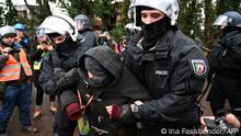 11.01.2023*****Policemen lead away an activist in the village of Luetzerath, western Germany, on January 11, 2023, as they started the evacuation of anti-coal activists staging an 'active defence' of the village, ahead of a planned demolition to expand a coal mine. - Police have secured approval from the state interior ministry to clear the village but activists have warned there will be no limits in its defence, giving rise to fears of violent confrontations. (Photo by INA FASSBENDER / AFP)
