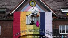 A climate activist hangs from a rope during a protest in the village of Luetzerath near Erkelenz, Germany, Wednesday, Jan. 11, 2023. Police on Wednesday entered a condemned village in western Germany, launching an effort to evict activists holed up at the site in an effort to prevent its demolition to make way for the expansion of a coal mine. (AP Photo/Michael Probst)