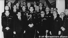 This April 26, 1967 image shows Greek officials and royals in Athens, Greece. Front row from left to right: Colonel George (Georgios) Papadopoulos (mp), premier Constantin Kollias, King Constantin II, deputy premier and defence minister Lt. General Grigorio Spatidakis, unidentified minister, Nicolas Economopoulos - industry, and minister for coordination Nicholas Makaezos. Behind the king left is interior minister brigadier general Stylanos Patacos and right secretary of state for defence Lt. Gen. George Zoitakis. (AP Photo)