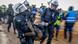 Police officers carry a demonstrator Police officers carry a demonstrator