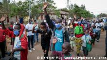 Thursday, Aug. 27, 2020++++Burundian refugees from Mahama camp in Rwanda wave to gathered media as they arrive back in Gasenyi, Burundi, Thursday, Aug. 27, 2020. Nearly 500 Burundian refugees living in Rwanda began their journey back to their home country Thursday, the first group to return from Rwanda after five years in exile following deadly political violence that sent many fleeing. (AP Photo/Berthier Mugiraneza)