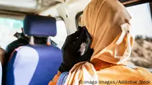 Back view of anonymous female traveler in stylish headscarf having phone conversation while sitting in car during trip in Egypt JavierBallester_Egypt_49.jpg Copyright: xJavierxBallesterx