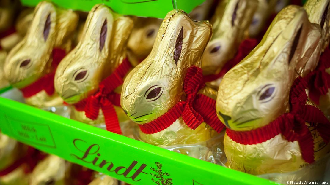Picture of cholocate bunnies wrapped in gold foil and with a red ribbon round their necks. 