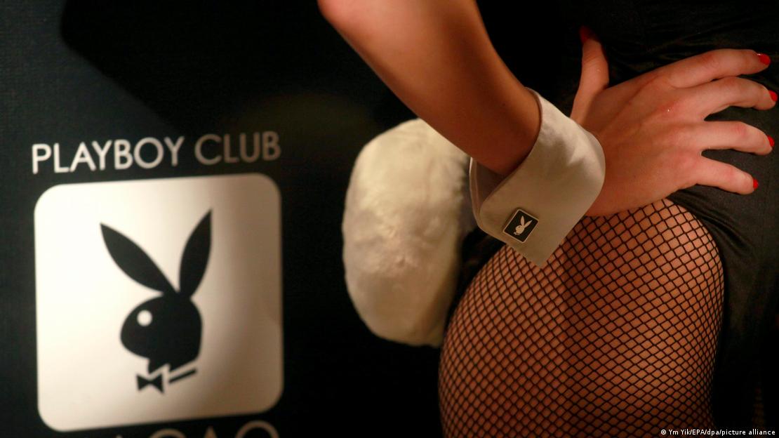 Picture of the logo of the Playboy Club and a woman wearing fishnet stockings with a bunny tail attached to her back.