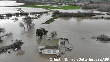 SALINAS, CALIFORNIA - JANUARY 13: In an aerial view, a home is seen submerged in floodwater as the Salinas River begins to overflow its banks on January 13, 2023 in Salinas, California. Several atmospheric river events continue to pound California with record rainfall and high winds. Justin Sullivan/Getty Images/AFP (Photo by JUSTIN SULLIVAN / GETTY IMAGES NORTH AMERICA / Getty Images via AFP)