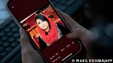 15.01.2023***A woman looks at a picture of former Afghan lawmaker Mursal Nabizada on her mobile phone, who was shot dead by gunmen last night at her house in Kabul on January 15, 2023. - Mursal Nabizada had been a member of parliament in the previous Western-backed regime who had turned down the opportunity to flee Afghanistan when the Taliban seized power in August 2021. Nabizada, along with one of her bodyguards, was shot dead at her house, Kabul police spokesman Khalid Zadran said on January 15. (Photo by Wakil KOHSAR / AFP)
