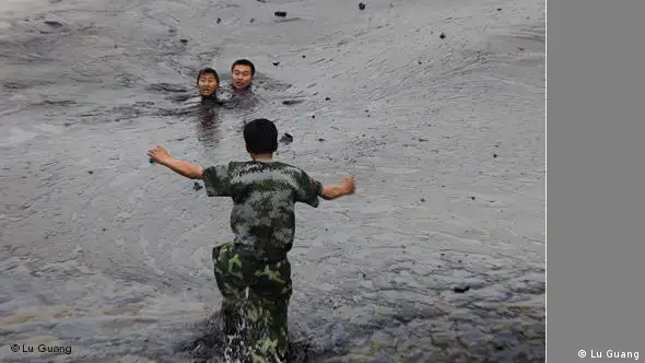 Spot News: 3rd prize stories Lu Guang, China, Greenpeace International. Firefighters in an oil spill cleanup attempt, Dalian, China, 20 July VERWENDUNG NUR BERICHTERSTATTUNG PREISVERLEIHUNG / BEKANNTGABE GEWINNER