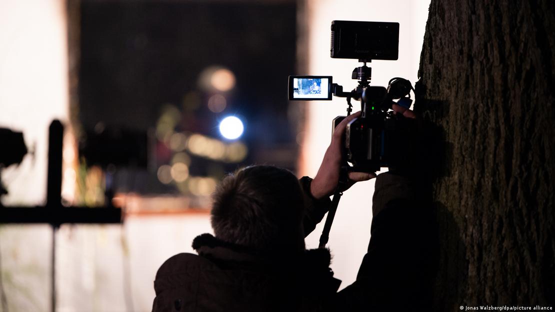 A reporter holding a camera A reporter holding a camera